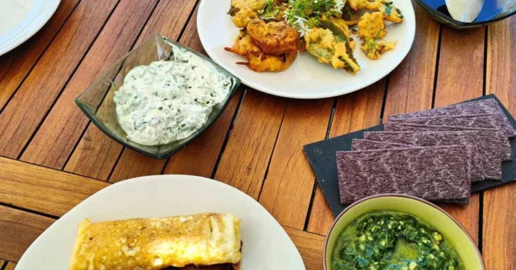 Assortiment de plats végétariens à partager sur une table en bois sur la terrasse, idéal pour le déjeuner de votre séminaire d'entreprise.